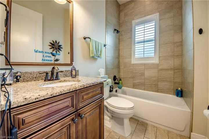 Bathroom with vanity and washtub / shower combination