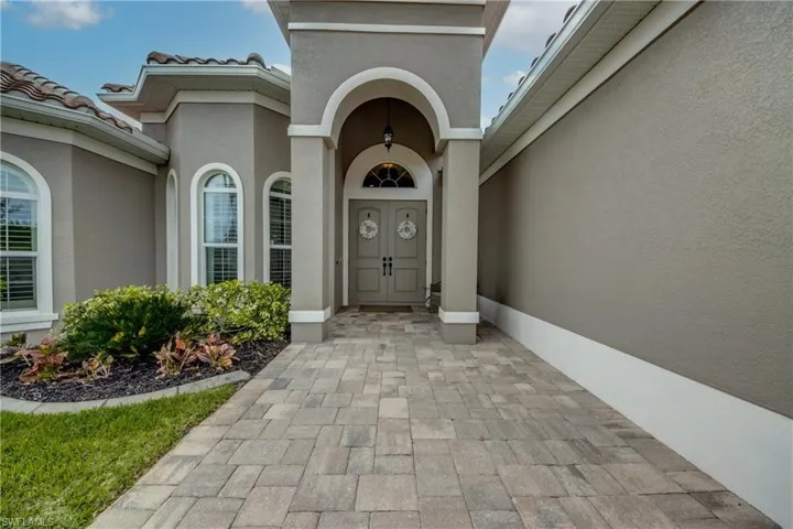 Property entrance featuring stucco siding and a tiled roof