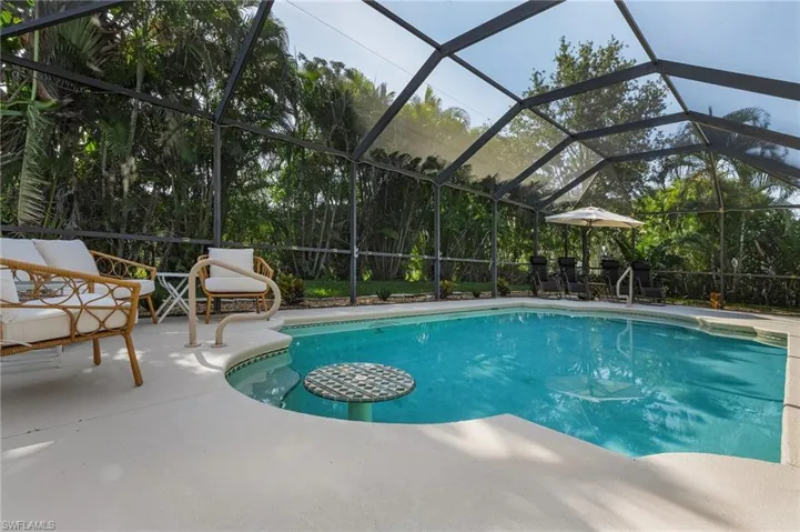 View of swimming pool featuring a lanai and a patio