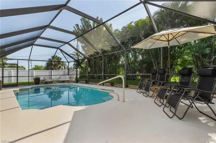 View of swimming pool featuring a patio and a lanai