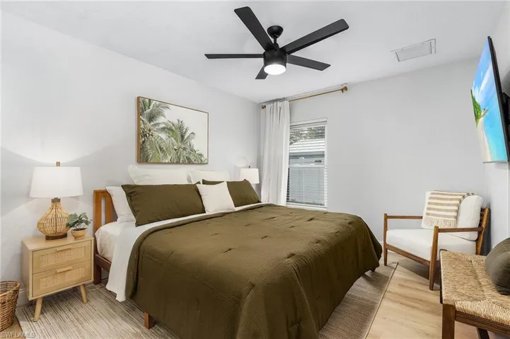 Bedroom with ceiling fan and light hardwood / wood-style flooring