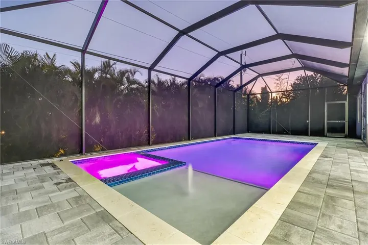 Combined pool / hot tub with a lanai full screened mansard pool cage