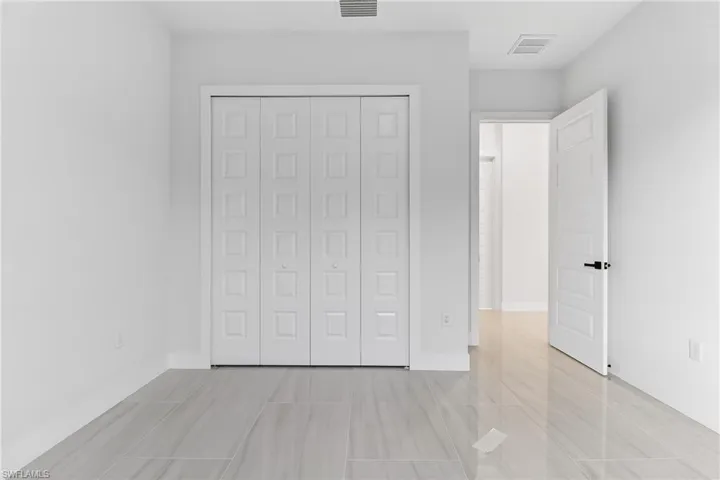 Unfurnished bedroom with a closet and baseboards
