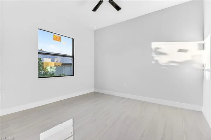 Spare room featuring baseboards and a ceiling fan