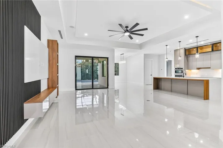 Greatroom featuring a raised ceiling, a ceiling fan, and recessed lighting