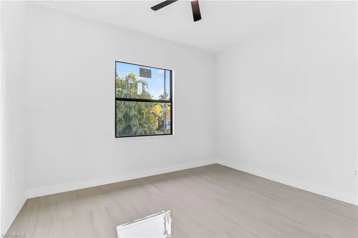 Unfurnished room featuring baseboards and a ceiling fan