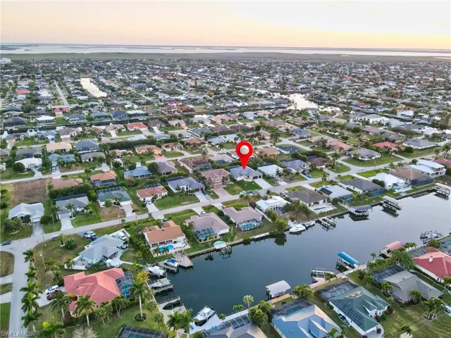 Aerial view of property's location with nearby suburban area and a nearby body of water