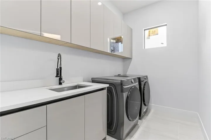 Laundry area featuring washing machine and dryer and cabinet space