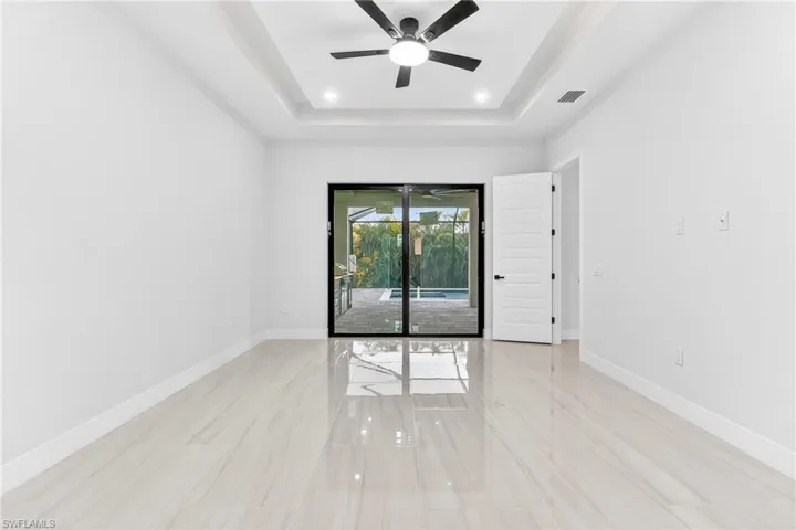 Spare room featuring ceiling fan, a raised ceiling, and recessed lighting
