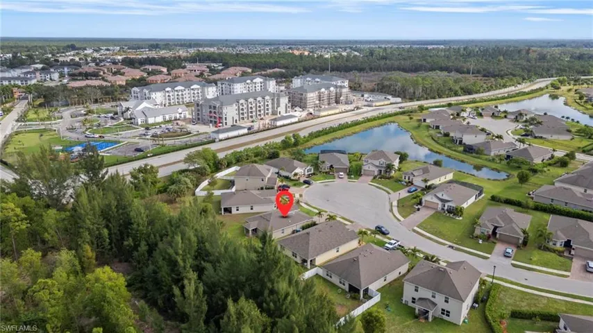 Aerial overview of property's location featuring a nearby body of water and nearby suburban area