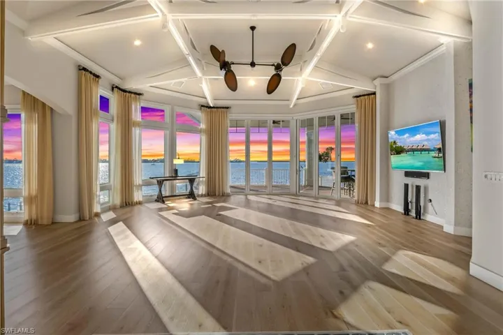 A wall of windows truly blends the outside and inside offering magnificent views, upgraded wood floors, and be sure to look at the ceiling - custom designed details and serene accent lighting!