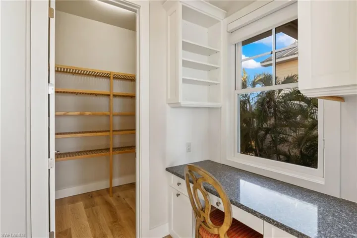 Tucked away by the kitchen, there is a nice niche office and cabinetry.  There is also a large walk in pantry that is very spacious and has wood shelving.