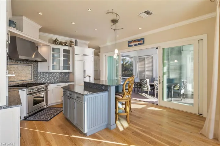 Gourmet chef kitchen with gas stove, Sub Zero fridge, custom designed cabinetry and access to the outdoor dining area!