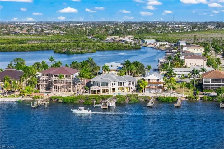 Back of home featuring extensive outdoor patios and living space and a sparkling pool and spa!