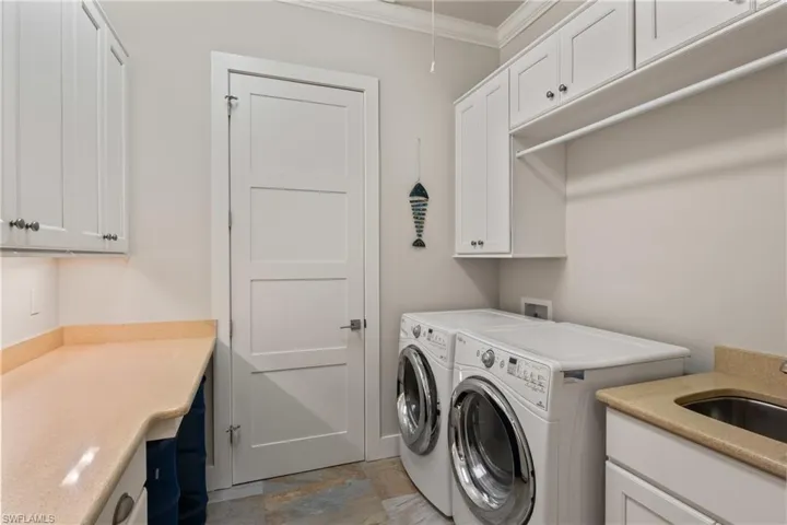 Oversized laundry room offering tons of storage, a generous closet, and a laundry tub, making everyday tasks easy and efficient.