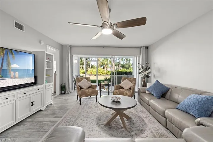 Living room featuring ceiling fan and light wood-style flooring