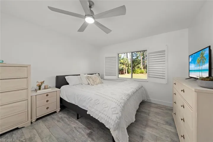 Bedroom with light wood-style flooring and a ceiling fan