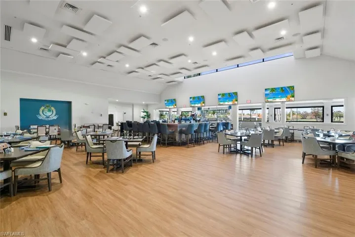 Dining space with light wood-style floors, lofted ceiling, and recessed lighting