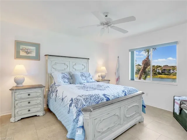Bedroom with ceiling fan and light tile patterned flooring