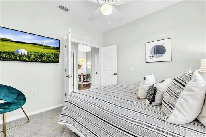 Interior room featuring light gray wall paint and gray carpeting