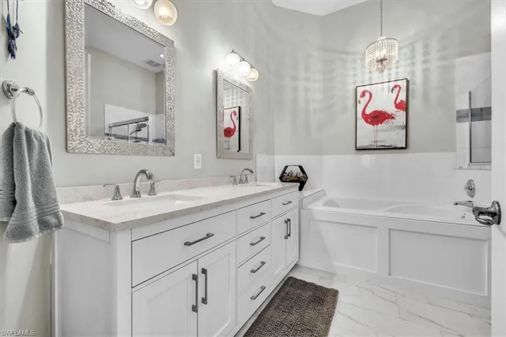 White dual vanity with undermount sinks and light-toned countertops