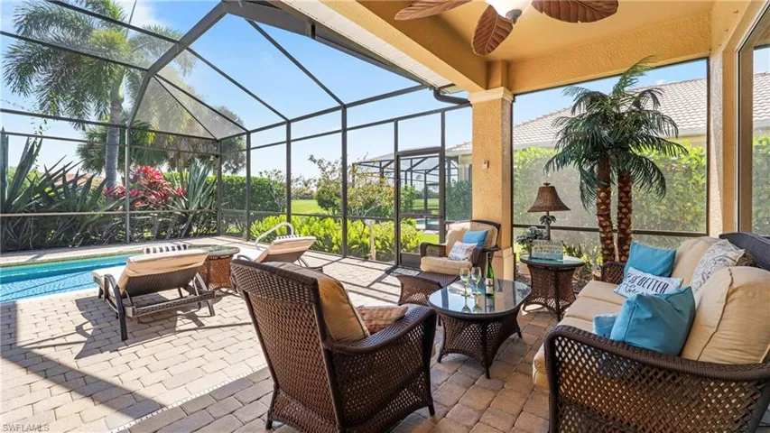 View of patio with outdoor furniture, a sunroom, a lanai, and an outdoor pool