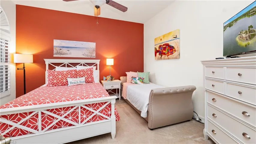 3rd Bedroom with a ceiling fan, light carpet, and an accent wall