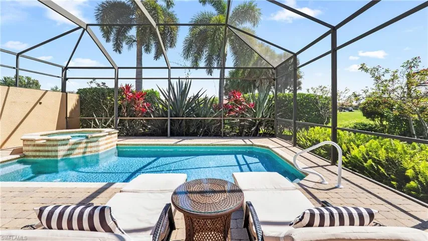 Relaxing pool / spa featuring a lanai and a sunroom