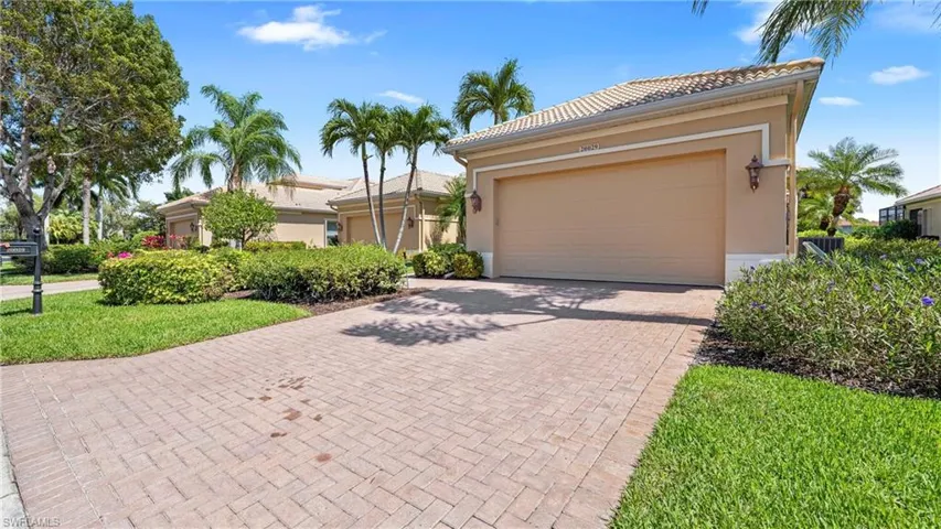 Ranch-style home featuring decorative driveway, stucco siding, a tile roof, and an attached garage