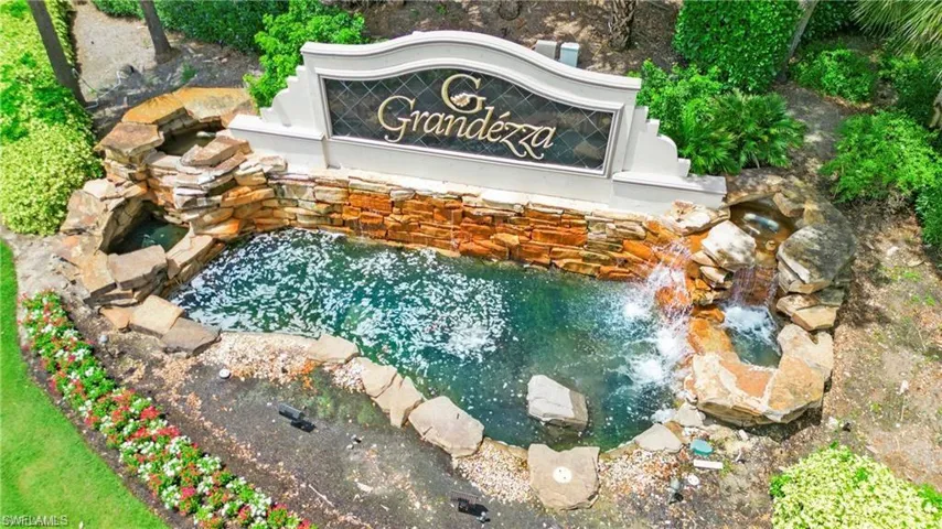 Community sign featuring a small pond