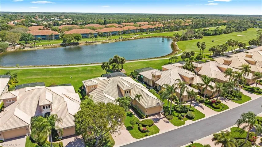 Aerial view of residential area with a large body of water and a local golf course