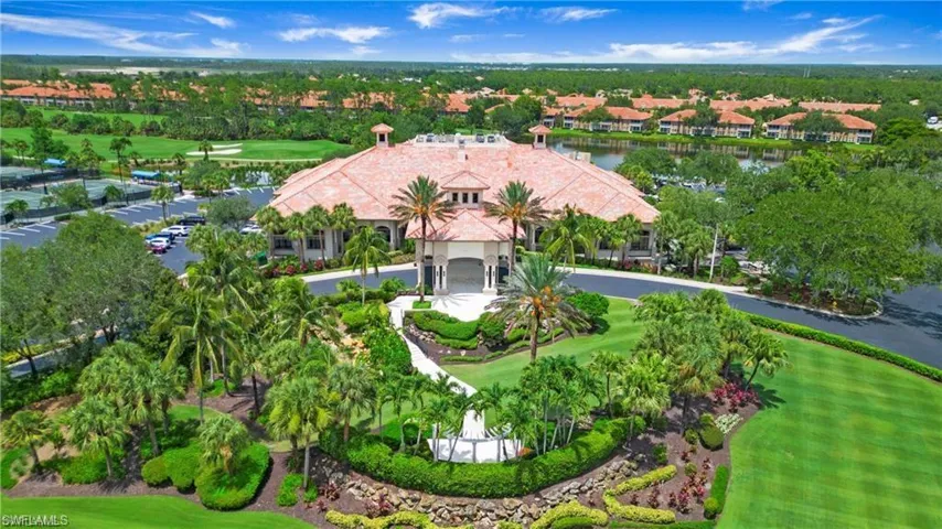 Aerial view of residential area with a local golf course and a large body of water