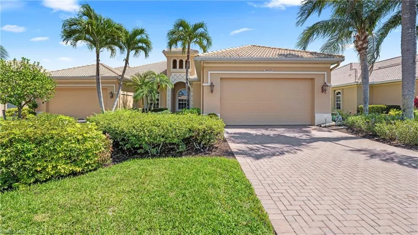 Mediterranean / spanish-style house with decorative driveway, an attached garage, stucco siding, and a tile roof