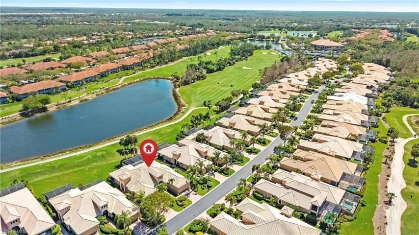 Aerial view of property's location with a nearby body of water and nearby suburban area