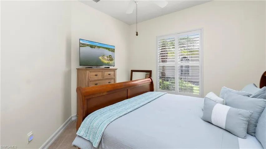 2nd Bedroom featuring light carpet and a ceiling fan