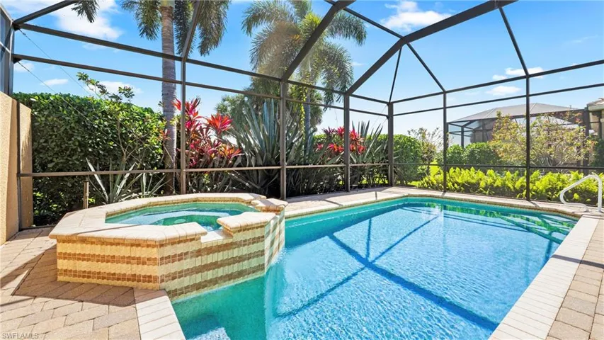 Relaxing pool / spa with a lanai, a sunroom, and a patio area