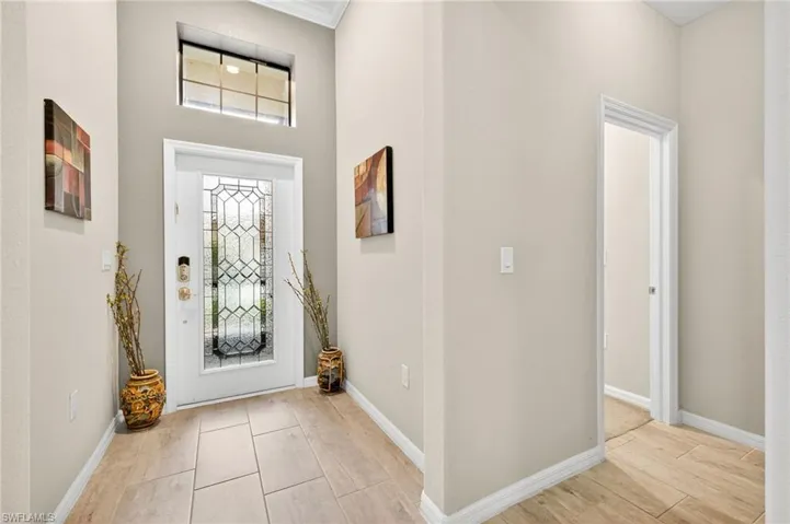 Foyer featuring baseboards and light wood-style flooring