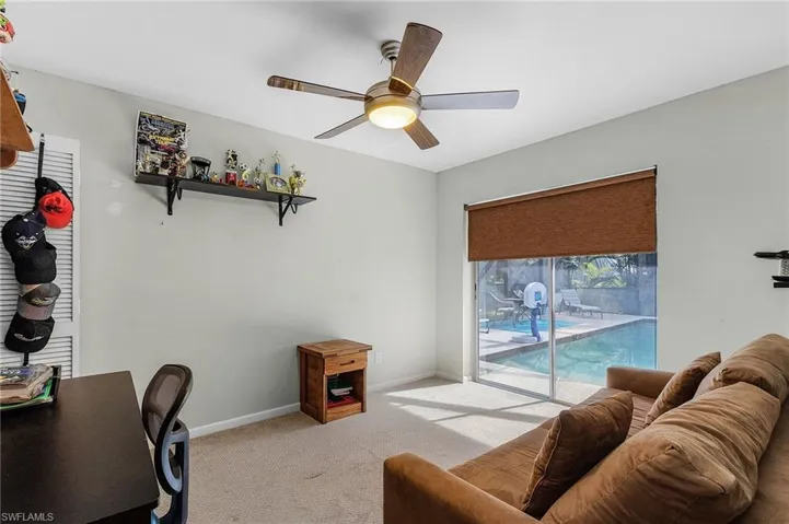 Carpeted office featuring ceiling fan