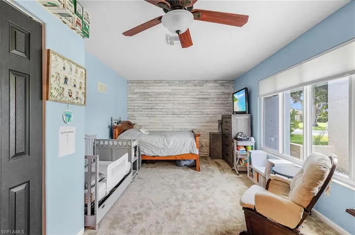 Carpeted bedroom with ceiling fan