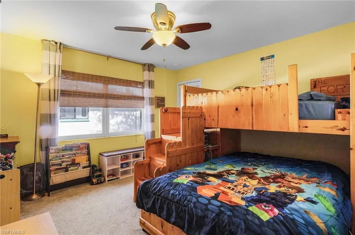 Bedroom with ceiling fan and carpet
