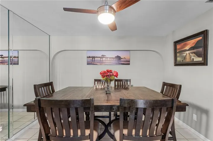 Tiled dining area featuring ceiling fan