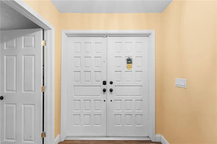 Entrance foyer with hardwood / wood-style flooring