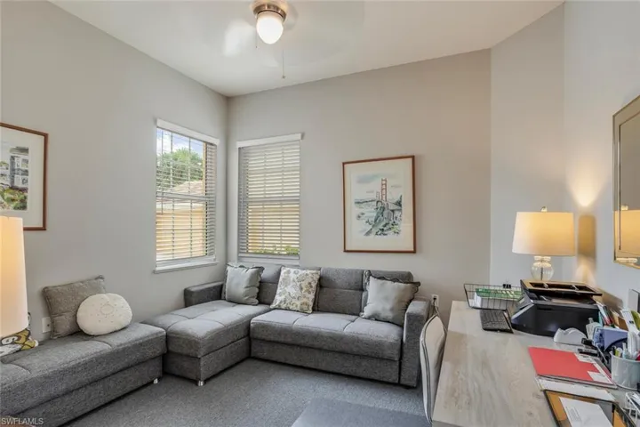 Living room featuring wood finished floors, a ceiling fan, and an office area