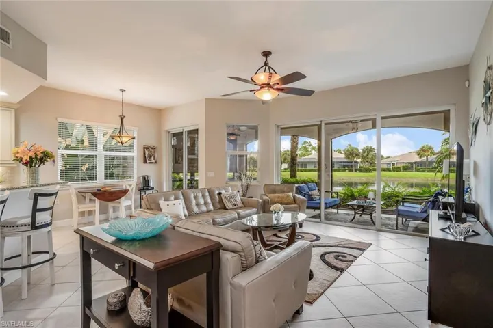 Living area with light tile patterned floors and ceiling fan