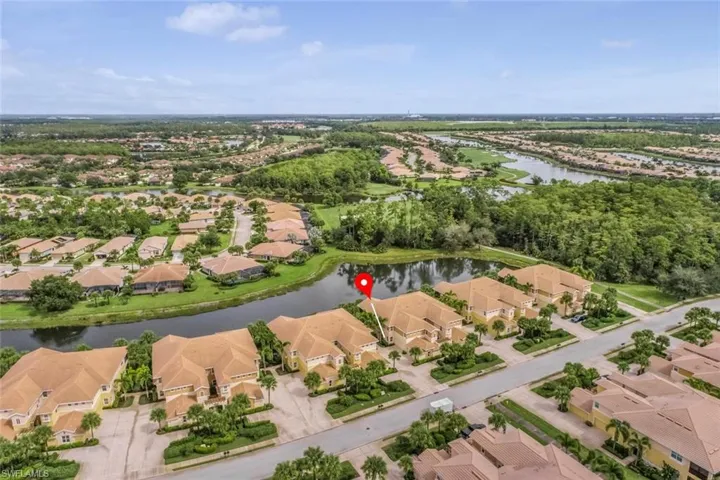 Aerial view of residential area featuring a large body of water