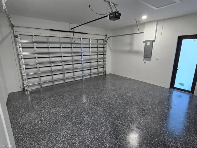 Garage with a garage door opener and electric panel