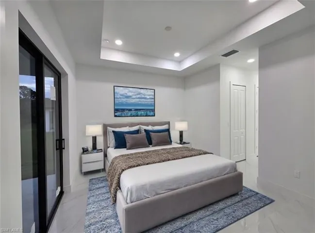 Bedroom featuring a closet, a raised ceiling, and access to outside. Virtually staged