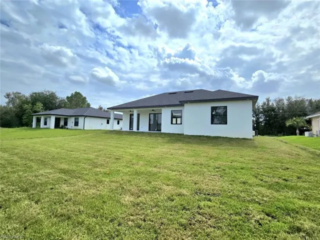 Back of house featuring a lawn