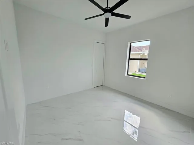 Spare room with ceiling fan