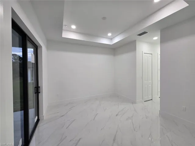 Spare room with a tray ceiling